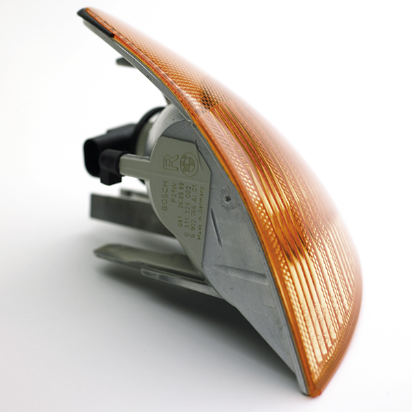Automotive indicator light assembly with orange lens, showcasing precision engineering for durable laser marking applications.