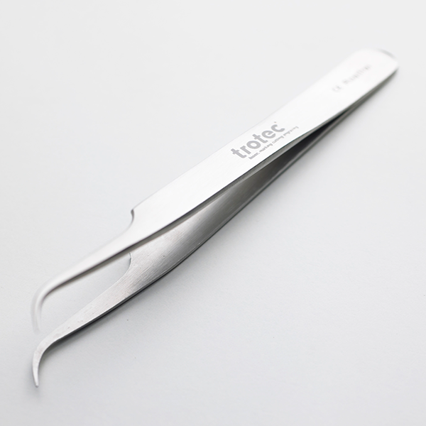 Stainless steel tweezers with precision tips, showcasing durability for laser marking applications in manufacturing.