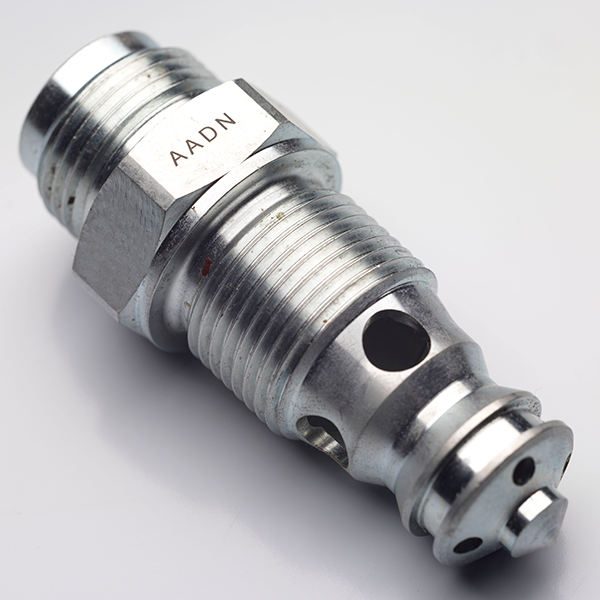 Metal valve component featuring precise laser marking with the code "AADN," showcasing Evright Industrial's capabilities in durable electrical marking solutions.
